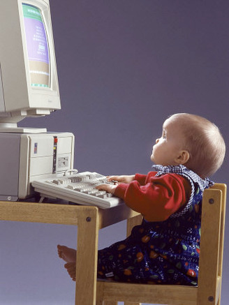 Baby Sitting at Desk Using Computer