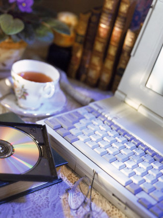 Laptop Computer, Cd-Rom, Cup of Tea, and Books