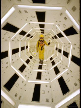 Distance Shot of Actor in Astronaut Suit Walking Through Geometrically Designed Hal Computer Center