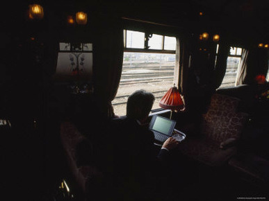 Man Works at His Laptop Computer Aboard the Orient Express