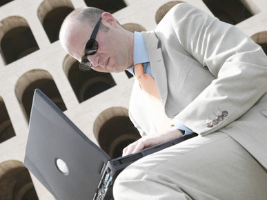 Male Mature Adult Businessman Sitting with Laptop Computer