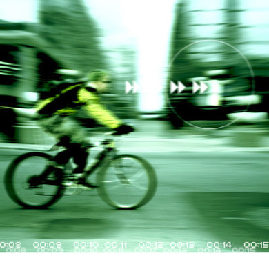 View of Man Riding Bicycle Through Computer Screen Lens