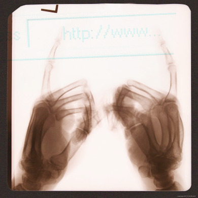 X-Ray of Hands Typing Web Address on Computer