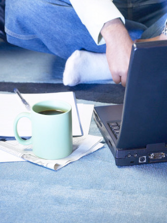 Mug of Coffee on Carpet Beside Laptop Computer
