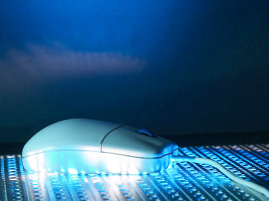 Computer Mouse on Metal Screen with Blue Light Illumination