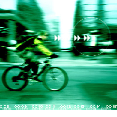 View of Man Riding Bicycle Through Computer Screen Lens