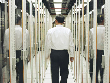 Man Walking Through a Computer Server Room