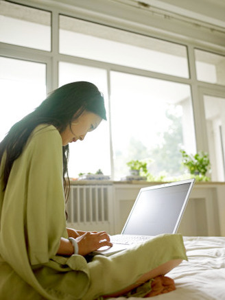 Young Woman in Her 20s to 30s Checking Email on Her Laptop Computer