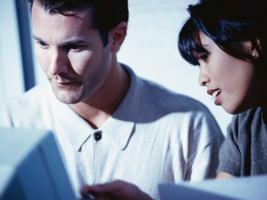Man and Woman Looking at Computer Screen