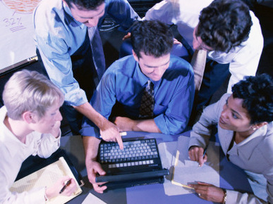 Group of People Gathered Around Laptop Computer, Overhead View